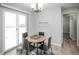 Bright dining room with a modern chandelier, and easy access to a sliding glass door to the outdoor patio at 1150 S Taos Way, Denver, CO 80223