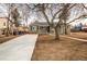 Ranch-style home with a long concrete driveway and healthy, mature trees at 1150 S Taos Way, Denver, CO 80223