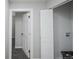 Hallway view featuring an open door and convenient access to laundry facilities at 1150 S Taos Way, Denver, CO 80223