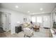 Spacious living room featuring modern decor, ample seating, and a seamless flow into the dining area at 1150 S Taos Way, Denver, CO 80223