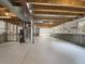Unfinished basement with painted floor and exposed ductwork and framing, providing ample storage space at 542 Hawthorn Cir, Frederick, CO 80530