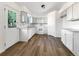 Well-lit kitchen features modern appliances, white cabinetry, and vinyl flooring at 542 Hawthorn Cir, Frederick, CO 80530