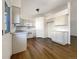 Bright kitchen with modern white appliances, light gray cabinets, and a doorway at 542 Hawthorn Cir, Frederick, CO 80530