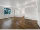 Bright living room with vaulted ceilings, wood floors, large windows, and fresh white paint at 542 Hawthorn Cir, Frederick, CO 80530
