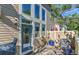Outdoor patio with grill and furniture set amongst plants and next to the back door at 11257 W Radcliffe Dr, Littleton, CO 80127