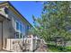 Townhome backyard featuring a manicured lawn, mature trees, and a clear blue sky at 11257 W Radcliffe Dr, Littleton, CO 80127