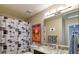 Well-lit bathroom featuring a granite vanity, large mirror, and a shower with a stylish patterned curtain at 11257 W Radcliffe Dr, Littleton, CO 80127