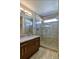 Modern bathroom featuring a glass-enclosed shower and granite vanity at 11257 W Radcliffe Dr, Littleton, CO 80127