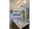 Bathroom featuring a large vanity with a white countertop and modern lighting at 11257 W Radcliffe Dr, Littleton, CO 80127