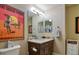 Bathroom with granite vanity and a stylish mirror, complemented by the decorative art and good lighting at 11257 W Radcliffe Dr, Littleton, CO 80127