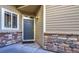 Welcoming front door with stone accents, window, and stylish hardware, inviting guests into the home at 11257 W Radcliffe Dr, Littleton, CO 80127