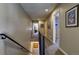 Second story hallway with modern railings and neutral wall decor at 11257 W Radcliffe Dr, Littleton, CO 80127
