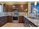 Stylish kitchen with stainless steel appliances, granite countertops, and ample cabinet space at 11257 W Radcliffe Dr, Littleton, CO 80127