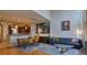 Open-concept living area with hardwood floors, modern decor, and seamless flow to the kitchen at 11257 W Radcliffe Dr, Littleton, CO 80127
