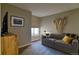 Cozy living room featuring a sofa, large window, and decorative wall art at 11257 W Radcliffe Dr, Littleton, CO 80127