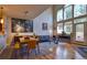 Bright living room with high ceilings, hardwood floors, and large windows offering scenic views at 11257 W Radcliffe Dr, Littleton, CO 80127
