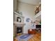 Cozy living room with fireplace, hardwood floors, accent rug and comfortable seating at 11257 W Radcliffe Dr, Littleton, CO 80127