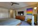Spacious bedroom featuring a closet, dresser, and unique wall decor at 11257 W Radcliffe Dr, Littleton, CO 80127