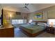Comfortable main bedroom with a ceiling fan, large window and an El Gallo art piece at 11257 W Radcliffe Dr, Littleton, CO 80127