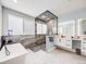 Luxurious bathroom boasting a standalone tub, glass-enclosed shower, and dual vanities at 3948 Wyandot St, Denver, CO 80211