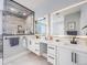 Elegant bathroom featuring double sinks, marble countertops, and a glass shower at 3948 Wyandot St, Denver, CO 80211