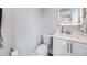 Updated half-bathroom with new vanity, toilet, and mirror at 3948 Wyandot St, Denver, CO 80211