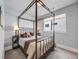 Cozy bedroom featuring a canopy bed, soft lighting, and neutral decor at 3948 Wyandot St, Denver, CO 80211