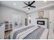 Inviting bedroom featuring a cozy fireplace, sliding glass doors, and a ceiling fan at 3948 Wyandot St, Denver, CO 80211