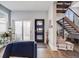 Welcoming entryway featuring a modern front door, a sliding glass door, an open staircase, and hardwood floors at 3948 Wyandot St, Denver, CO 80211