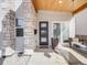 Charming entryway with a sleek front door, stone accents, a swing on the porch, and modern curb appeal at 3948 Wyandot St, Denver, CO 80211