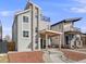 Modern home with a stone tower, cozy porch, balcony, manicured landscaping, and contemporary architectural details at 3948 Wyandot St, Denver, CO 80211