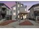 Contemporary two-story home with stone accents, a balcony, a porch with a swing, and modern curb appeal at 3948 Wyandot St, Denver, CO 80211