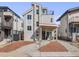 This contemporary two-story home features stone accents, a balcony, a welcoming porch with a swing, and great curb appeal at 3948 Wyandot St, Denver, CO 80211