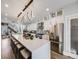 Modern kitchen with an expansive island, stainless steel appliances, and sleek white cabinetry at 3948 Wyandot St, Denver, CO 80211
