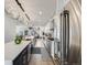 Bright, open kitchen with a spacious island, stainless steel refrigerator, and modern finishes at 3948 Wyandot St, Denver, CO 80211
