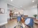 Open-concept living space featuring hardwood floors, a fireplace, dining area, and plenty of natural light at 3948 Wyandot St, Denver, CO 80211