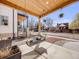 Relaxing front porch featuring a swing, overhead wood beams, a concrete patio, and ornamental hanging plants at 3948 Wyandot St, Denver, CO 80211