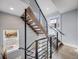 Modern staircase with wood steps, metal railings, and ample natural light at 3948 Wyandot St, Denver, CO 80211
