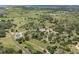 Expansive aerial view showcasing the home's private setting, pond, outbuildings, and surrounding landscape at 1140 Lake Gulch Rd, Castle Rock, CO 80104