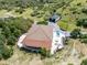 Stunning aerial view of a home with a swimming pool, outdoor patio, garage, and surrounding lush landscape at 1140 Lake Gulch Rd, Castle Rock, CO 80104