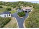 Aerial view of estate highlighting the main house, guest house, circular drive, and surrounding landscape at 1140 Lake Gulch Rd, Castle Rock, CO 80104