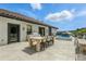 Inviting backyard patio with a dining table, outdoor kitchen, and a refreshing plunge pool for luxurious outdoor living at 1140 Lake Gulch Rd, Castle Rock, CO 80104