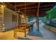 Charming covered patio featuring a dining area with a unique rope swing, ideal for relaxed outdoor entertaining at 1140 Lake Gulch Rd, Castle Rock, CO 80104