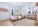 Bright bedroom with twin daybeds, wicker chairs, and a built-in vanity with framed mirrors at 1140 Lake Gulch Rd, Castle Rock, CO 80104