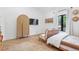 Bright bedroom with a closet and twin rattan daybeds with a large window at 1140 Lake Gulch Rd, Castle Rock, CO 80104