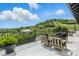 Backyard deck with black metal railing and comfortable outdoor seating with views of the surrounding landscape at 1140 Lake Gulch Rd, Castle Rock, CO 80104