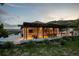 Stunning exterior view of home with beautiful outdoor living space and hillside views at 1140 Lake Gulch Rd, Castle Rock, CO 80104