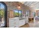 Charming kitchen sink area with stainless steel fixtures, farmhouse-style decor, and a view of the outdoors at 1140 Lake Gulch Rd, Castle Rock, CO 80104