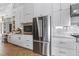Bright kitchen featuring stainless steel appliances, custom white cabinets, and ample counter space at 1140 Lake Gulch Rd, Castle Rock, CO 80104