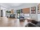 Bright, open-concept living room features herringbone floors, modern decor, and access to outdoor area at 1140 Lake Gulch Rd, Castle Rock, CO 80104